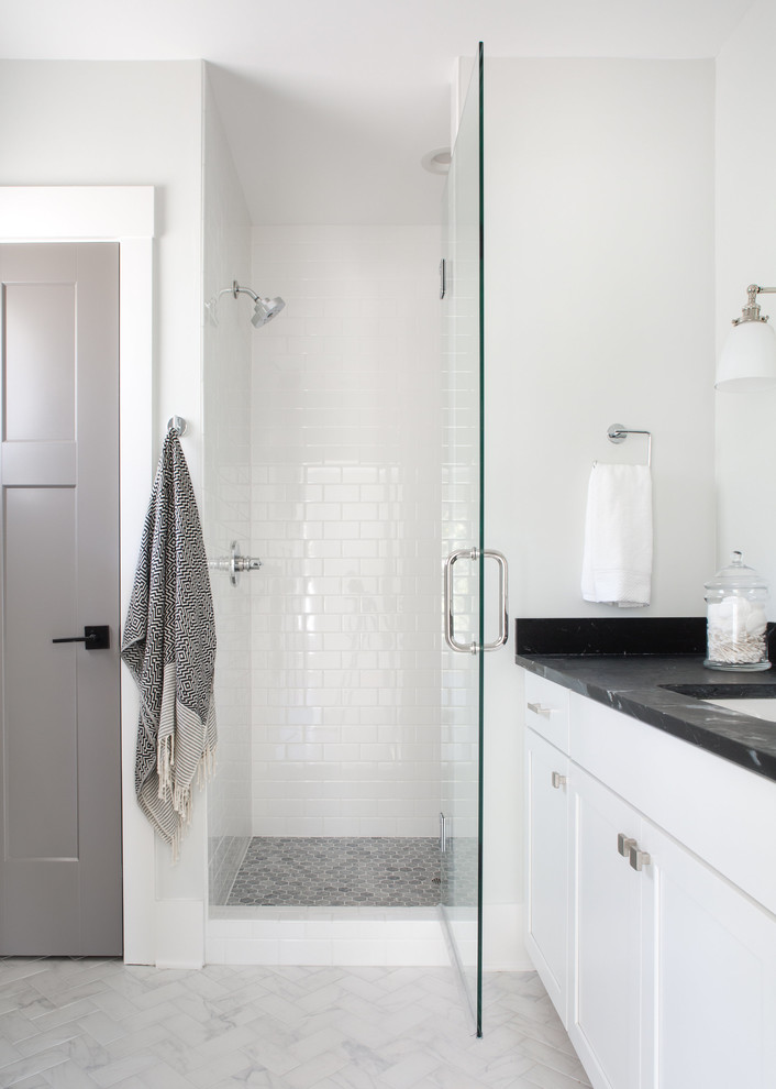Inspiration for a mid-sized transitional 3/4 bathroom in Charleston with shaker cabinets, white cabinets, an alcove shower, white tile, subway tile, white walls, marble floors, an undermount sink, soapstone benchtops, grey floor and a hinged shower door.