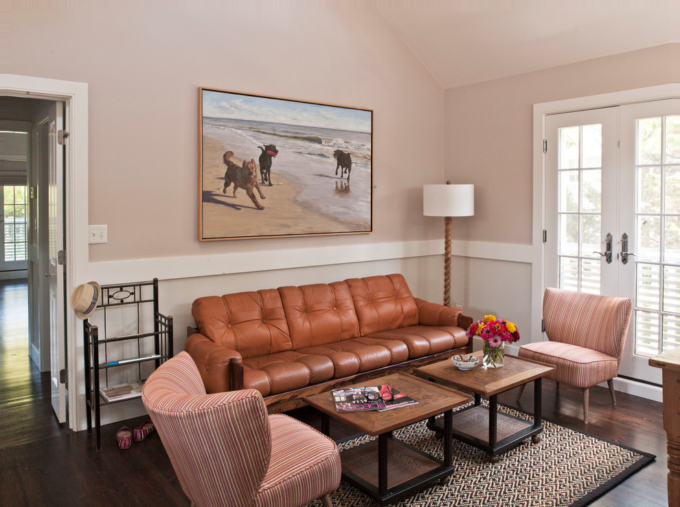 This is an example of a beach style living room in New York with pink walls, dark hardwood floors and brown floor.