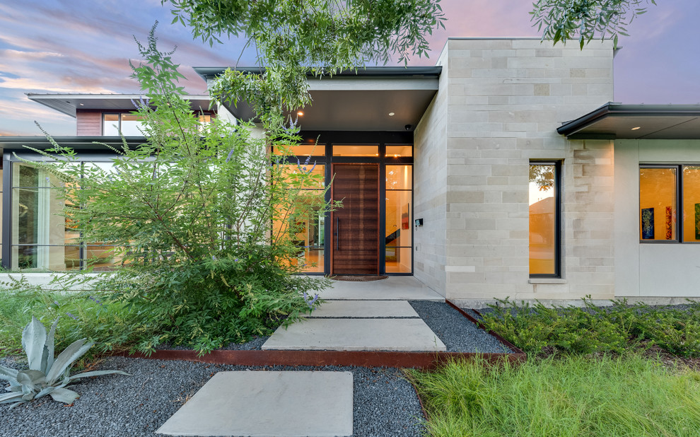 Inspiration for a contemporary front door remodel in Dallas with a dark wood front door