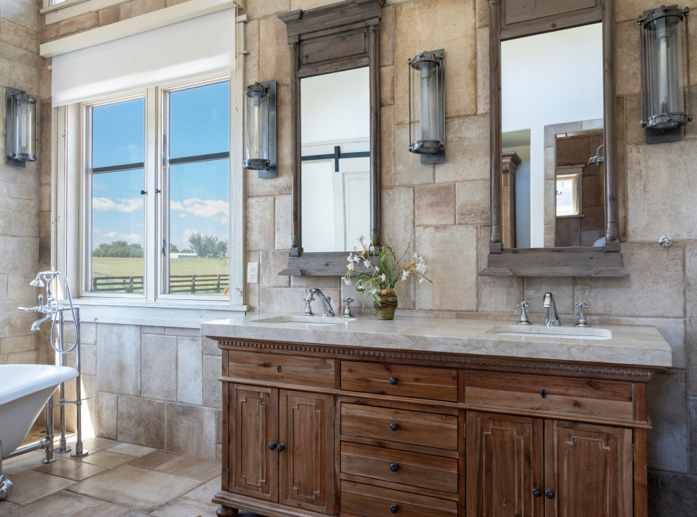 Design ideas for a country bathroom in Denver with recessed-panel cabinets, medium wood cabinets, a claw-foot tub, beige tile, an undermount sink, beige floor and beige benchtops.