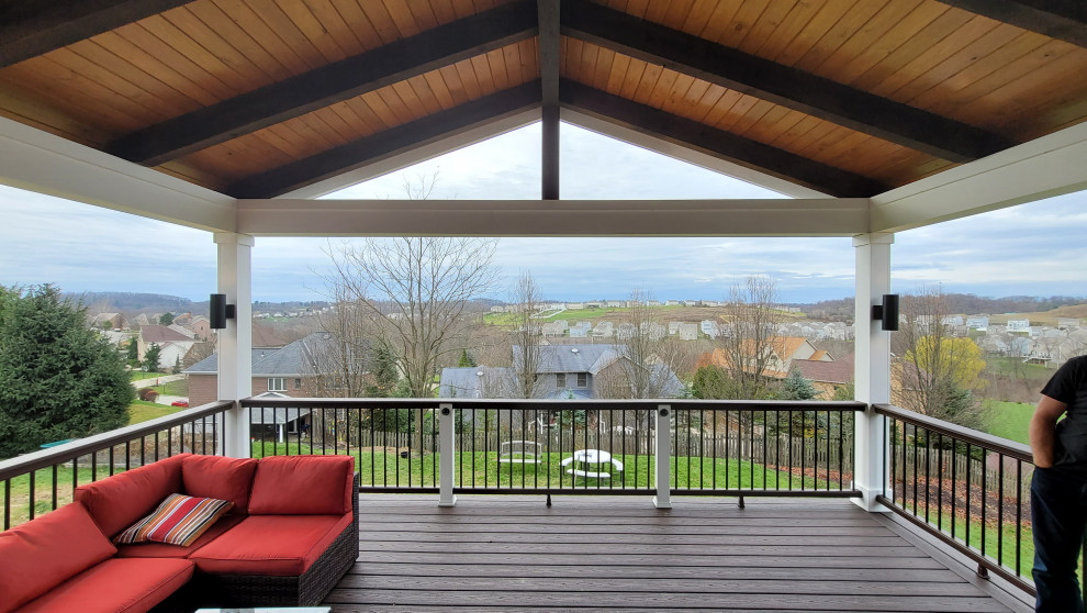 Inspiration for a mid-sized backyard second story metal railing deck remodel with a roof extension