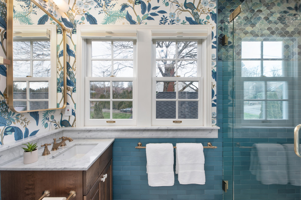 Inspiration for a small traditional 3/4 bathroom in Portland with recessed-panel cabinets, dark wood cabinets, an alcove shower, a one-piece toilet, blue tile, ceramic tile, blue walls, ceramic floors, a drop-in sink, marble benchtops, white floor, a hinged shower door, white benchtops, a niche, a single vanity, a built-in vanity and wallpaper.