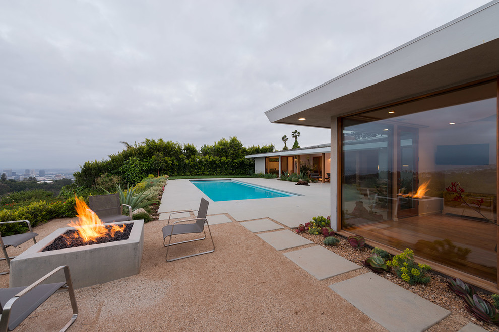 Inspiration for a mid-sized modern backyard patio in Los Angeles with a fire feature, decomposed granite and no cover.