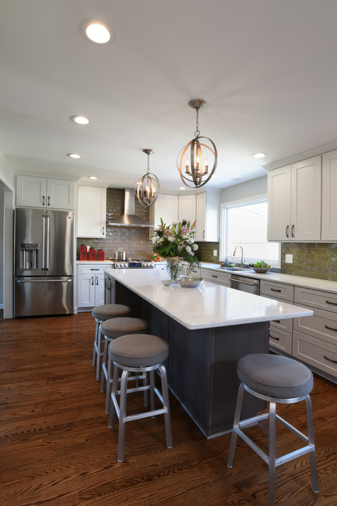 Transitional l-shaped medium tone wood floor eat-in kitchen photo in Orange County with a double-bowl sink, shaker cabinets, white cabinets, marble countertops, gray backsplash, glass tile backsplash, stainless steel appliances and an island