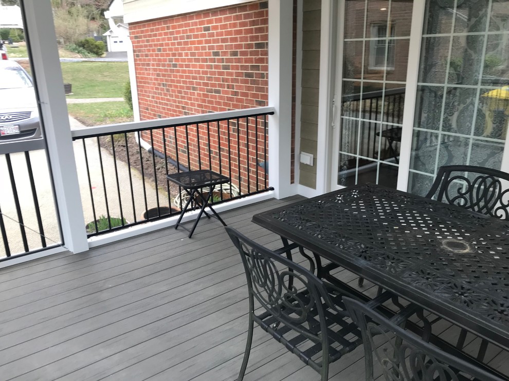 This is an example of a small contemporary side yard screened-in verandah in Baltimore with decking and a roof extension.