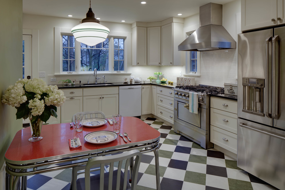 Photo of a mid-sized transitional l-shaped separate kitchen in New York with an undermount sink, shaker cabinets, white cabinets, quartz benchtops, white splashback, ceramic splashback, stainless steel appliances, linoleum floors and no island.