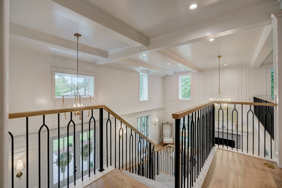 Staircase - large traditional wooden l-shaped mixed material railing and wall paneling staircase idea in Oklahoma City with painted risers