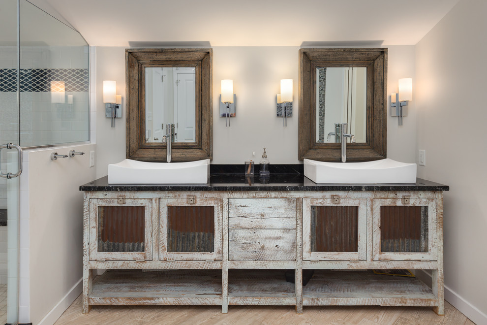 Example of a mountain style light wood floor bathroom design in DC Metro with distressed cabinets, beige walls, a vessel sink and a hinged shower door