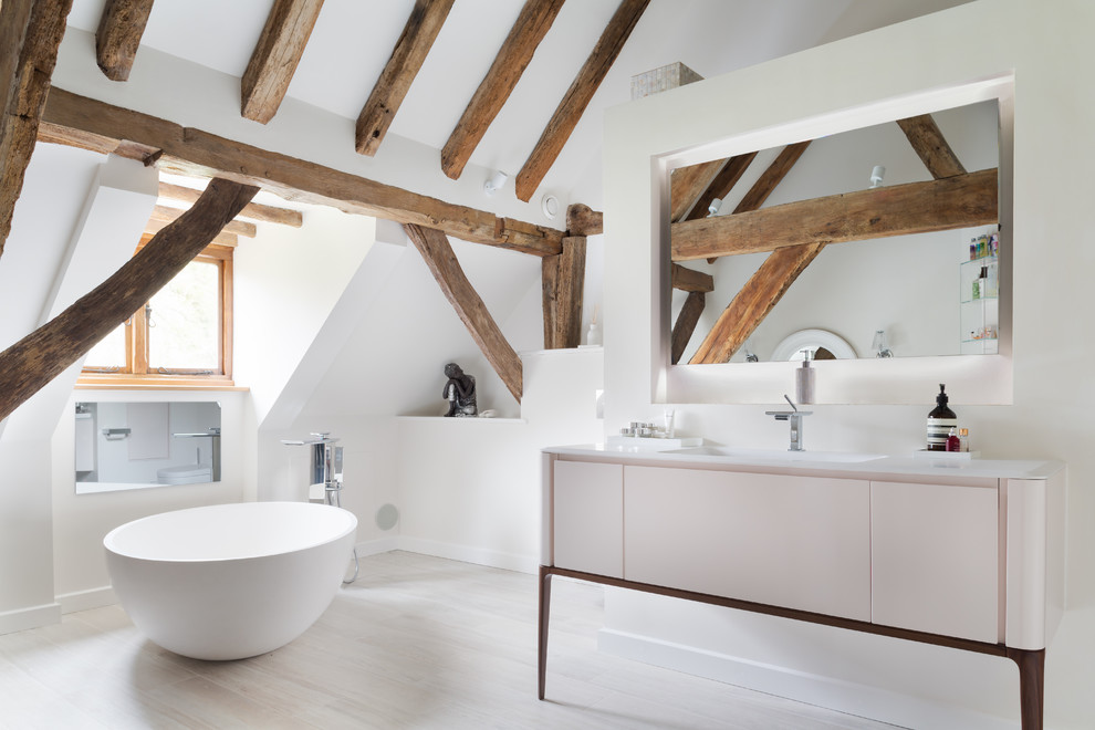 Photo of a country bathroom in Sussex with a freestanding tub, an alcove shower, a wall-mount toilet, yellow walls, a console sink and an open shower.