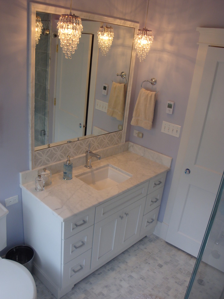 Mid-sized traditional kids bathroom in Chicago with beaded inset cabinets, white cabinets, a freestanding tub, a shower/bathtub combo, a two-piece toilet, gray tile, stone tile, purple walls, terra-cotta floors, an undermount sink, granite benchtops, white floor, a hinged shower door and white benchtops.