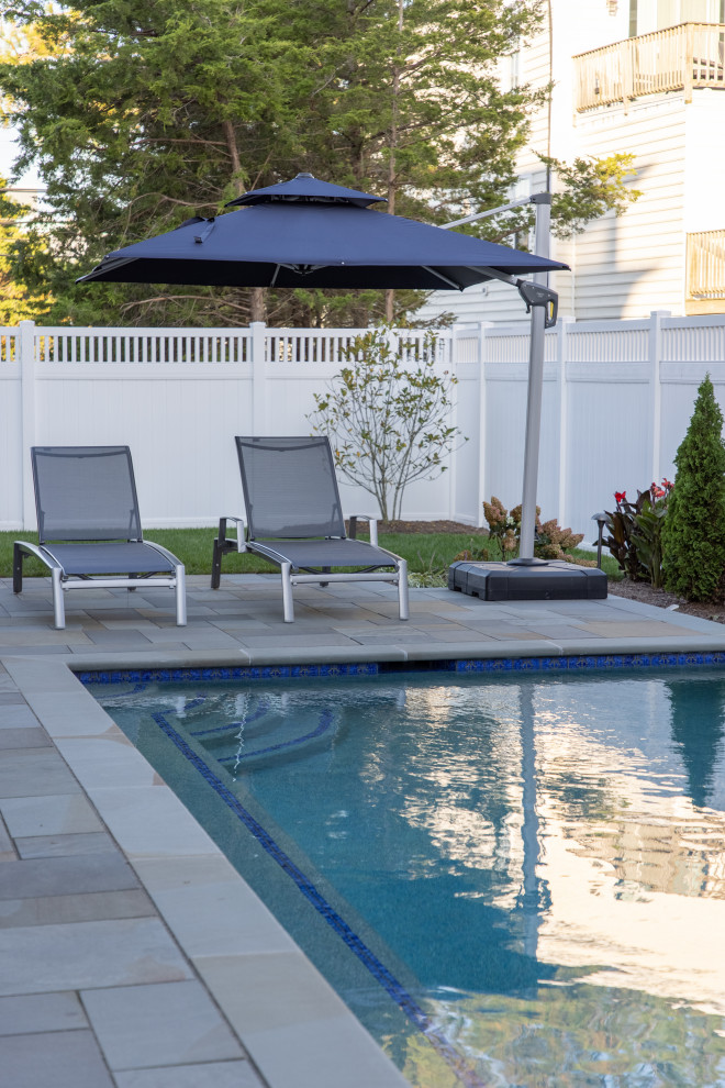 Inspiration for a small beach style backyard rectangular pool in Other with natural stone pavers.