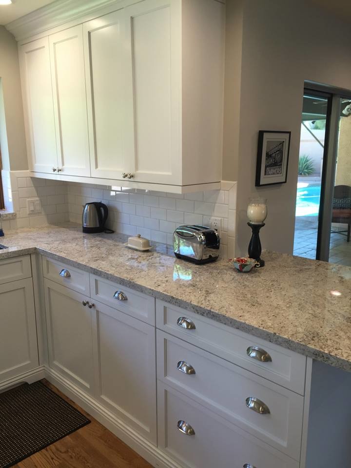 Kitchen - large transitional medium tone wood floor kitchen idea in Phoenix with an undermount sink, shaker cabinets, white cabinets, granite countertops, white backsplash, subway tile backsplash, stainless steel appliances and an island