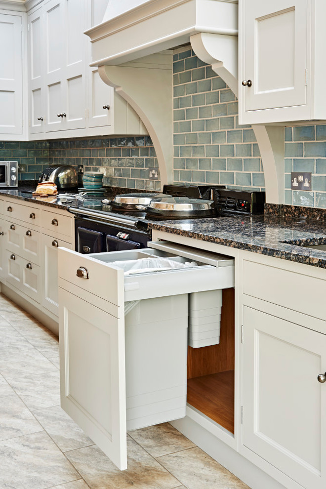 Mid-sized country eat-in kitchen in London with a farmhouse sink, shaker cabinets, granite benchtops, blue splashback, ceramic splashback, stainless steel appliances and with island.
