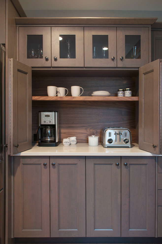 Kitchen pantry - mid-sized transitional kitchen pantry idea in Burlington with shaker cabinets, gray cabinets, quartz countertops, brown backsplash and stainless steel appliances
