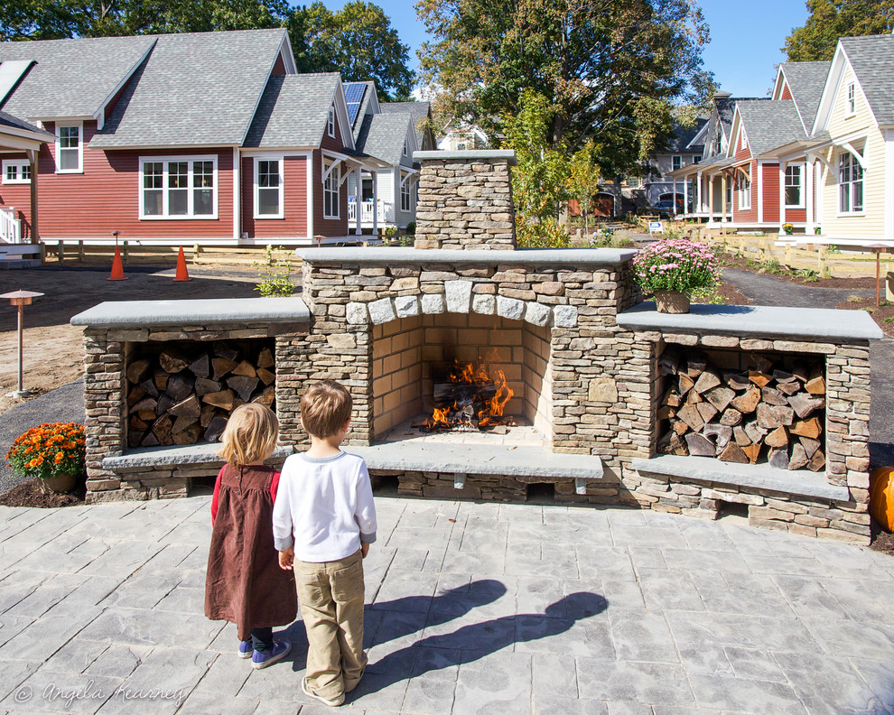 Inspiration for a mid-sized eclectic backyard patio in Boston with a fire feature and stamped concrete.