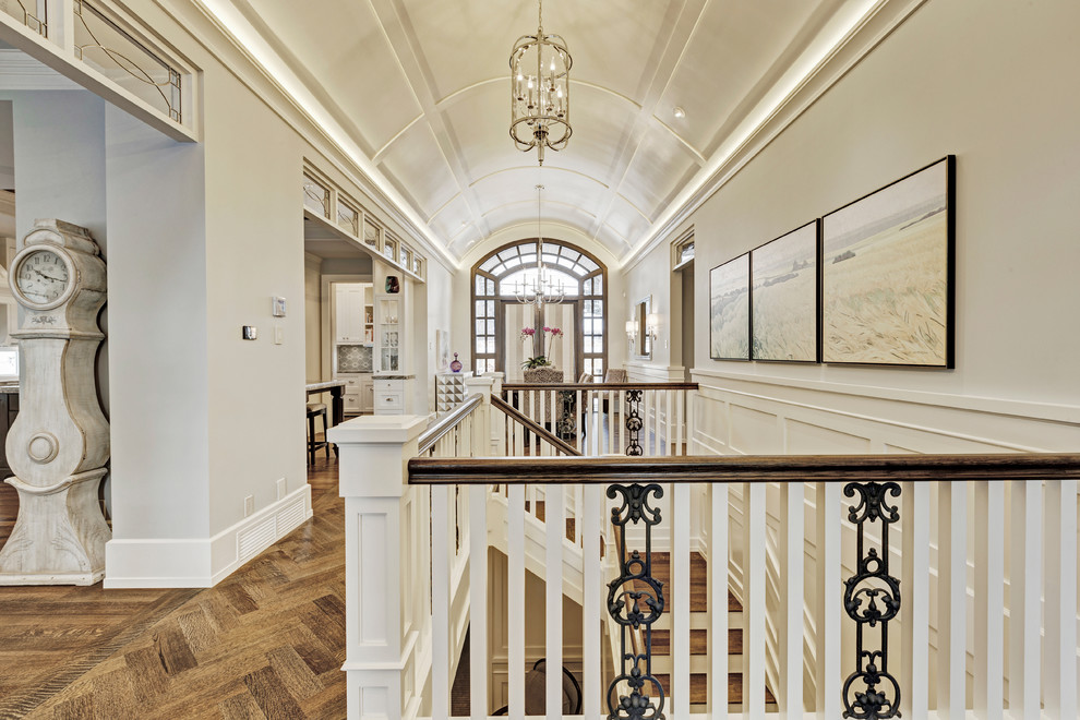 Large transitional medium tone wood floor entry hall photo in Calgary with beige walls and a dark wood front door