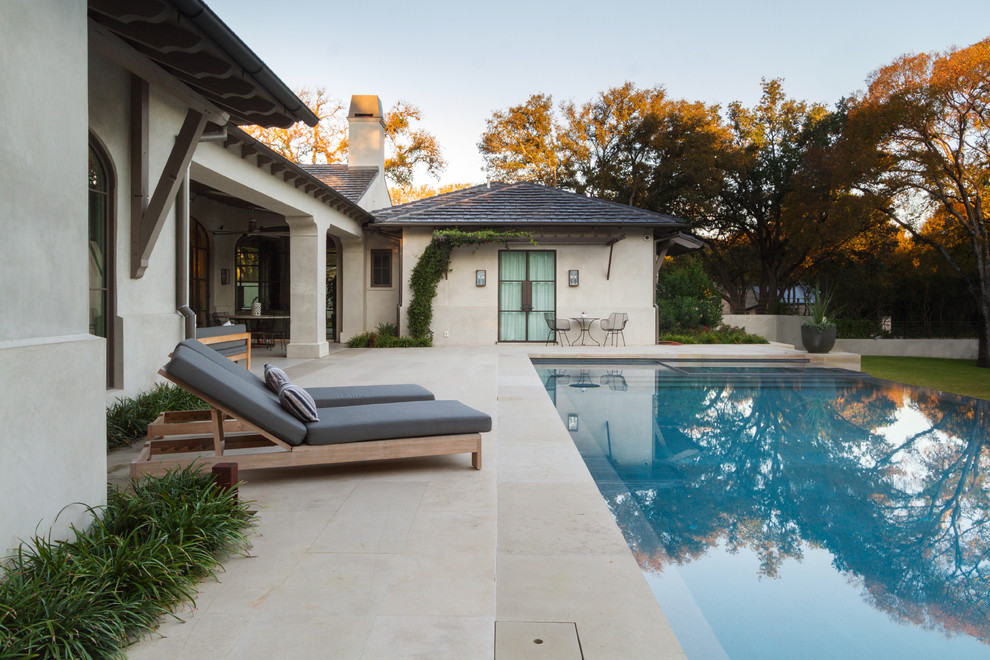 Design ideas for a mid-sized mediterranean backyard rectangular lap pool in Austin with a water feature and concrete pavers.