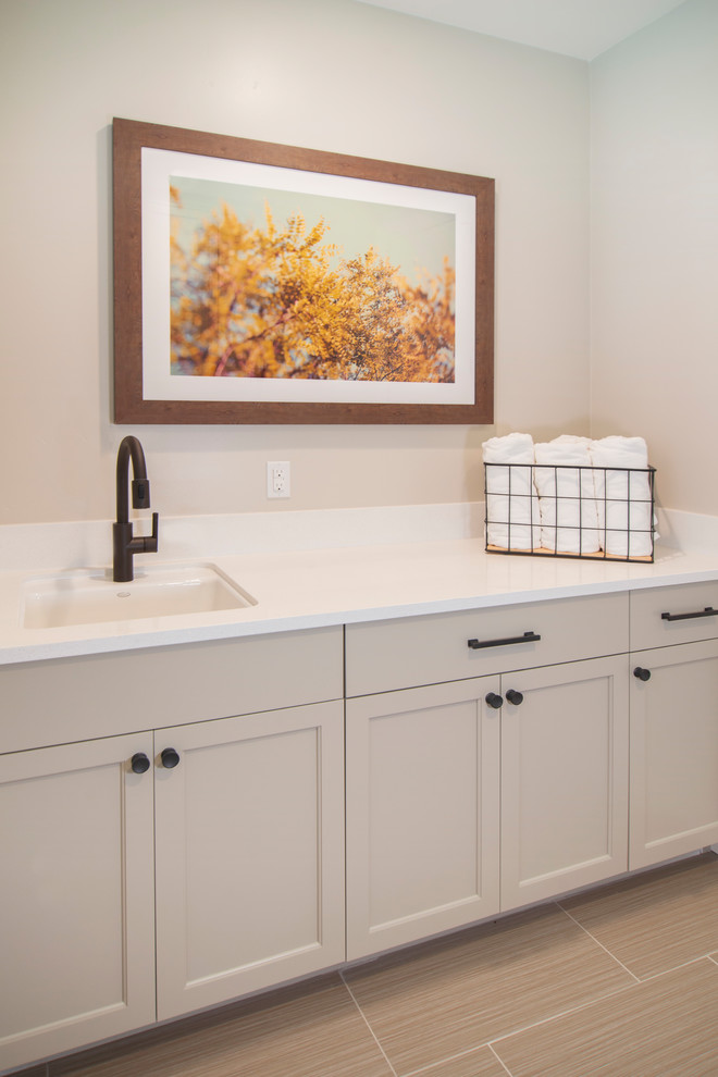 Inspiration for a transitional galley laundry room in San Francisco with recessed-panel cabinets and grey cabinets.