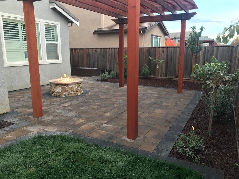 Photo of a large contemporary backyard partial sun xeriscape in San Francisco with a fire feature and concrete pavers.
