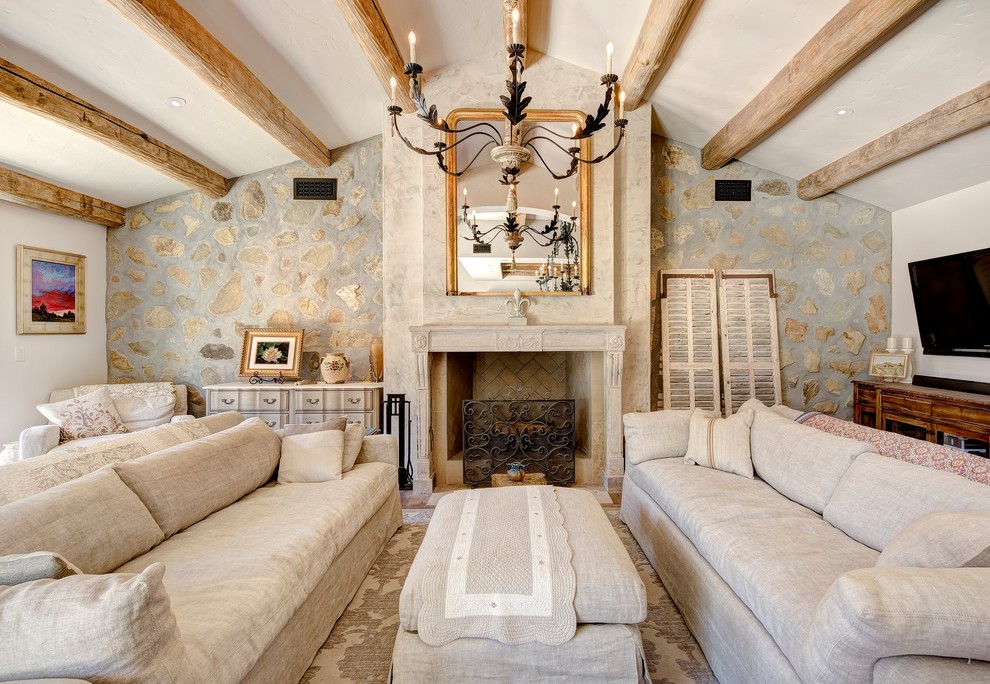 Living room - french country living room idea in Los Angeles with gray walls, a standard fireplace and a wall-mounted tv