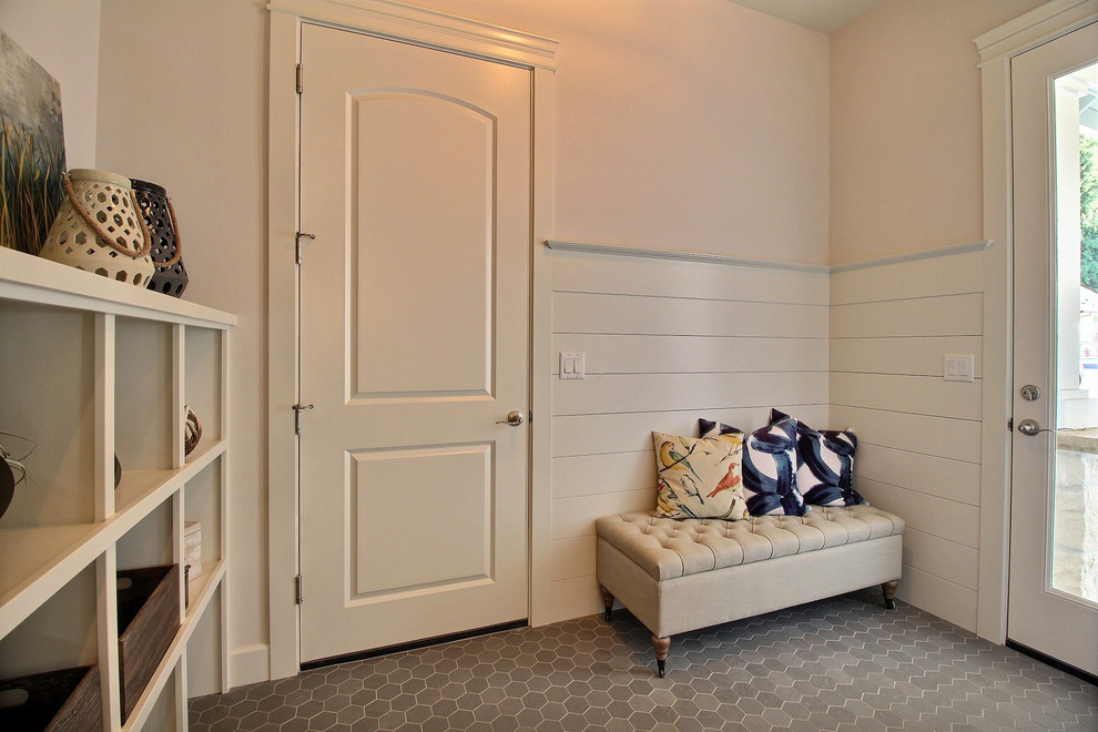 Example of a large arts and crafts porcelain tile and gray floor mudroom design in Portland with beige walls and a white front door