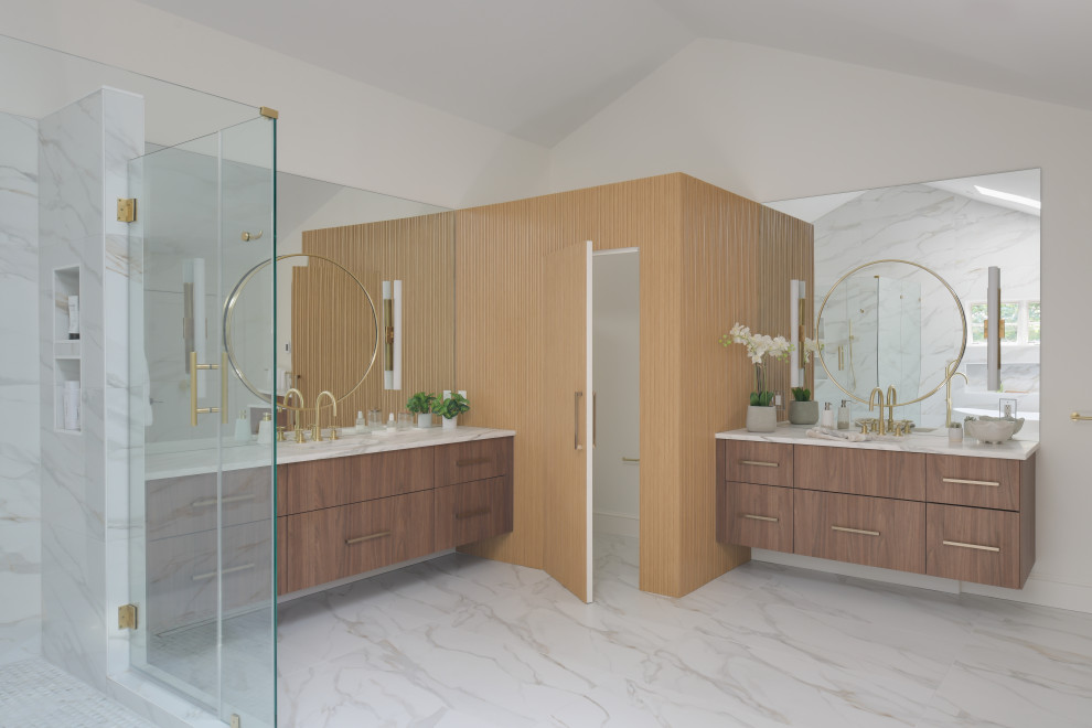 Photo of an expansive modern ensuite bathroom in DC Metro with flat-panel cabinets, medium wood cabinets, a freestanding bath, a corner shower, a bidet, white tiles, porcelain tiles, white walls, porcelain flooring, a submerged sink, marble worktops, white floors, a hinged door, white worktops, a shower bench, double sinks, a floating vanity unit, a vaulted ceiling and panelled walls.