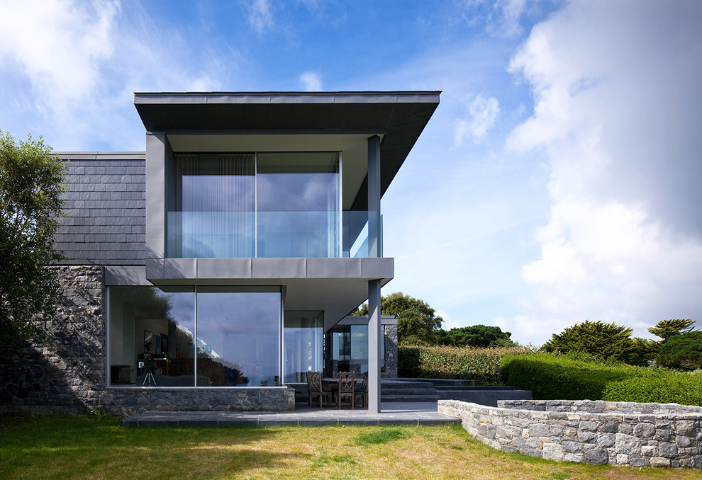 This is an example of a contemporary two-storey exterior in Channel Islands with a flat roof.