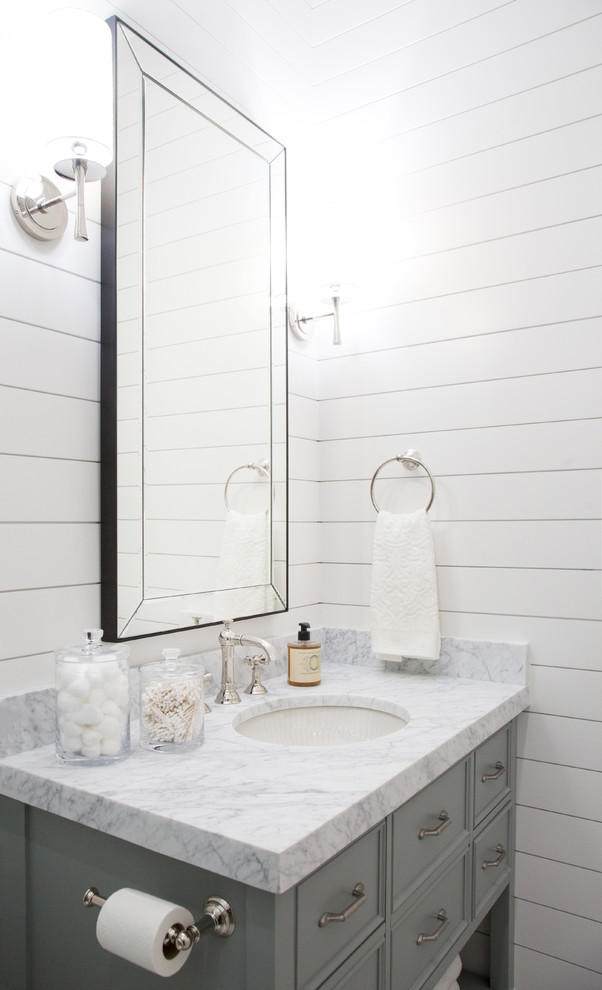 This is an example of a mid-sized arts and crafts 3/4 bathroom in Austin with beaded inset cabinets, green cabinets, an open shower, a one-piece toilet, white tile, marble, white walls, an undermount sink, marble benchtops and a sliding shower screen.
