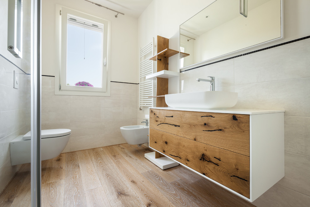 Photo of a modern master bathroom in Venice with flat-panel cabinets, medium wood cabinets, a one-piece toilet and painted wood floors.