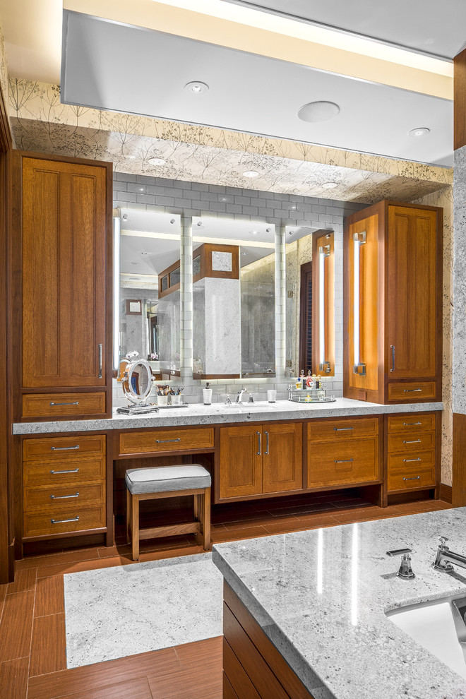 Large traditional master bathroom in Boston with medium wood cabinets, an undermount tub, gray tile, grey walls, marble, marble benchtops, brown floor, recessed-panel cabinets, ceramic floors and an undermount sink.