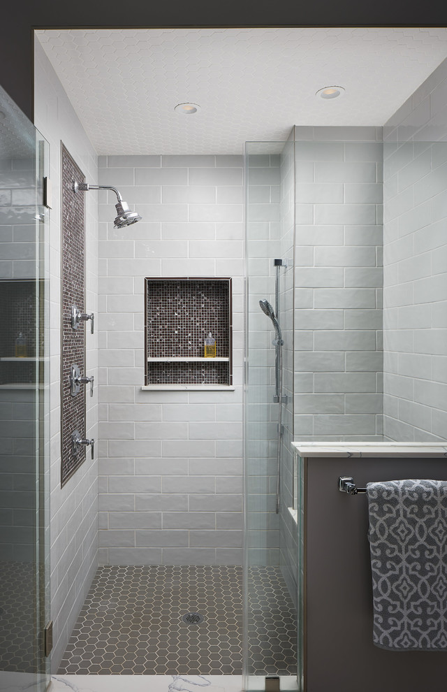 Photo of a large transitional master bathroom in Other with flat-panel cabinets, medium wood cabinets, a freestanding tub, a double shower, a two-piece toilet, gray tile, ceramic tile, grey walls, porcelain floors, an undermount sink, marble benchtops, grey floor, a hinged shower door and red benchtops.