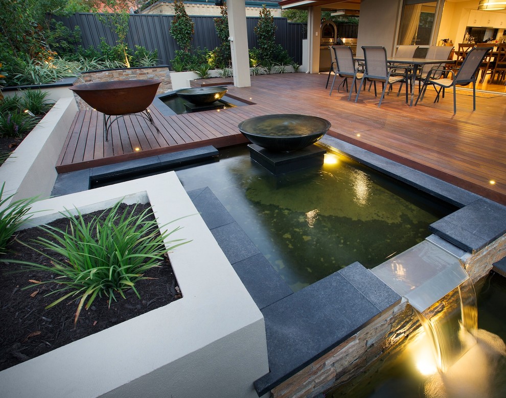 Inspiration for a contemporary backyard deck in Perth with a water feature and a roof extension.