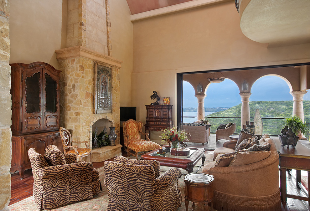 Design ideas for a mediterranean living room in Austin with a standard fireplace and a stone fireplace surround.