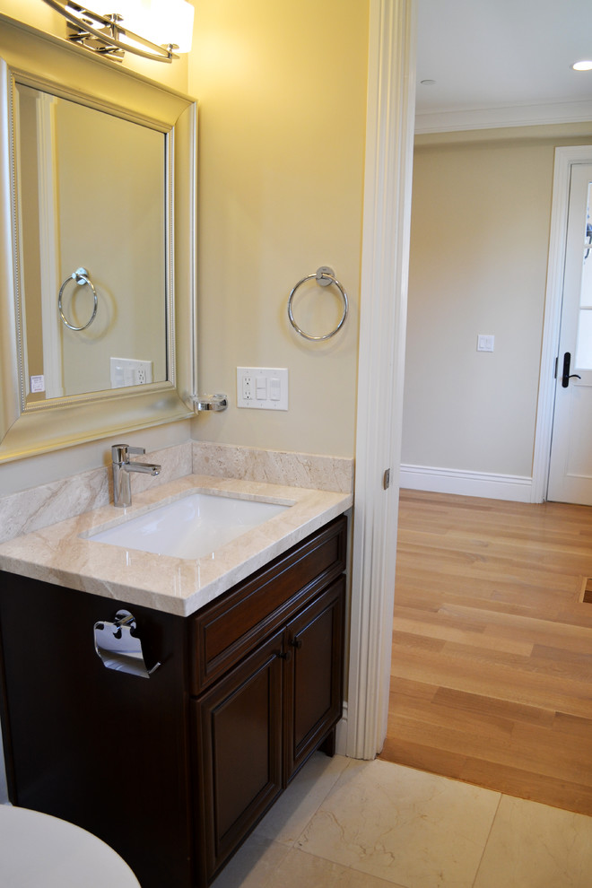 Photo of a traditional bathroom in San Francisco with flat-panel cabinets, dark wood cabinets, marble benchtops and beige walls.