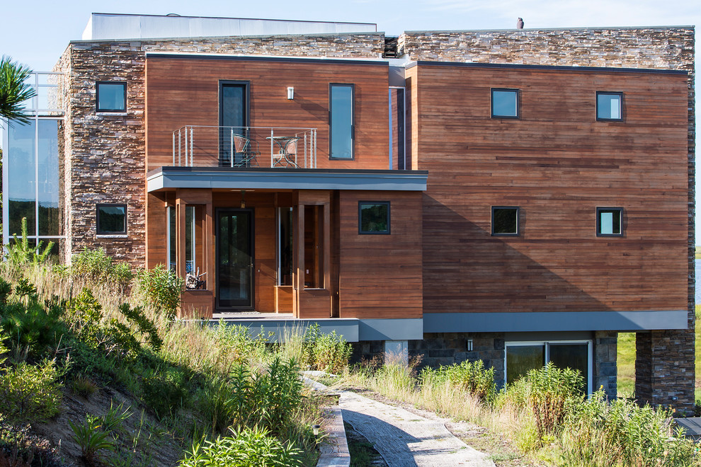 This is an example of a contemporary exterior in Boston with mixed siding.