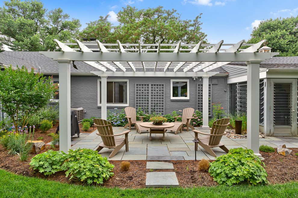 This is an example of a mid-sized transitional backyard patio in Wilmington with concrete pavers and a gazebo/cabana.