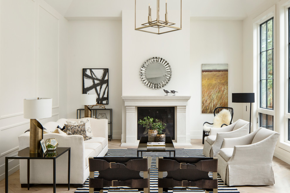 Inspiration for a transitional enclosed living room in Calgary with white walls, light hardwood floors, a standard fireplace and a concrete fireplace surround.
