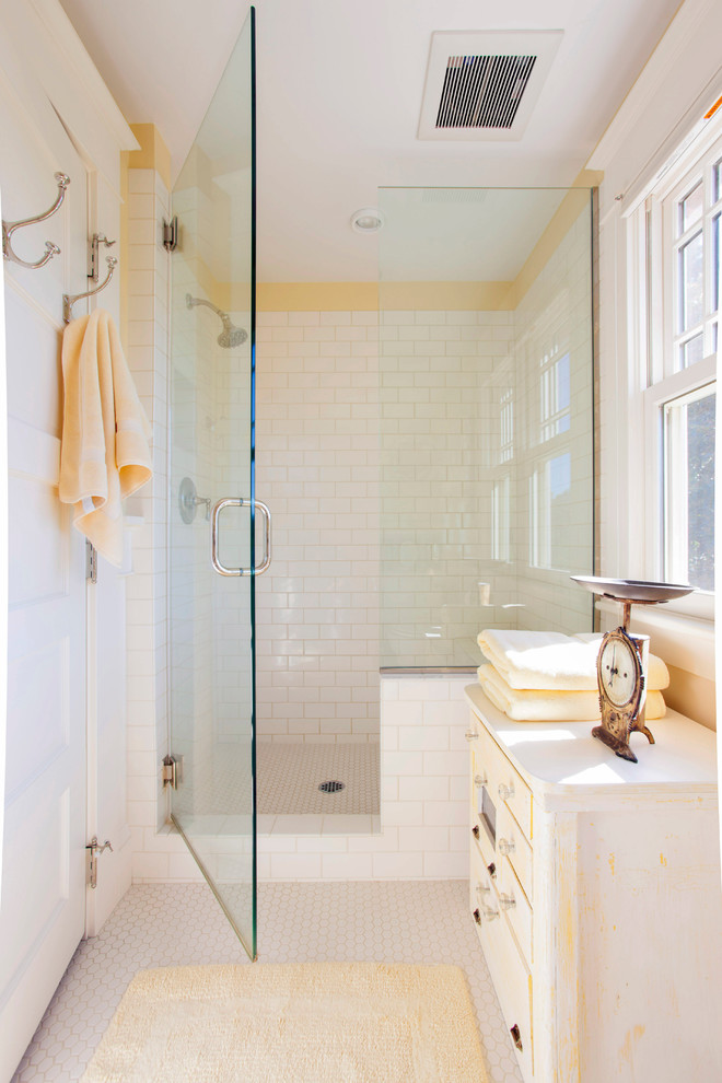Mid-sized transitional 3/4 bathroom in Portland with furniture-like cabinets, distressed cabinets, an alcove shower, a two-piece toilet, white tile, ceramic tile, yellow walls, mosaic tile floors and a pedestal sink.