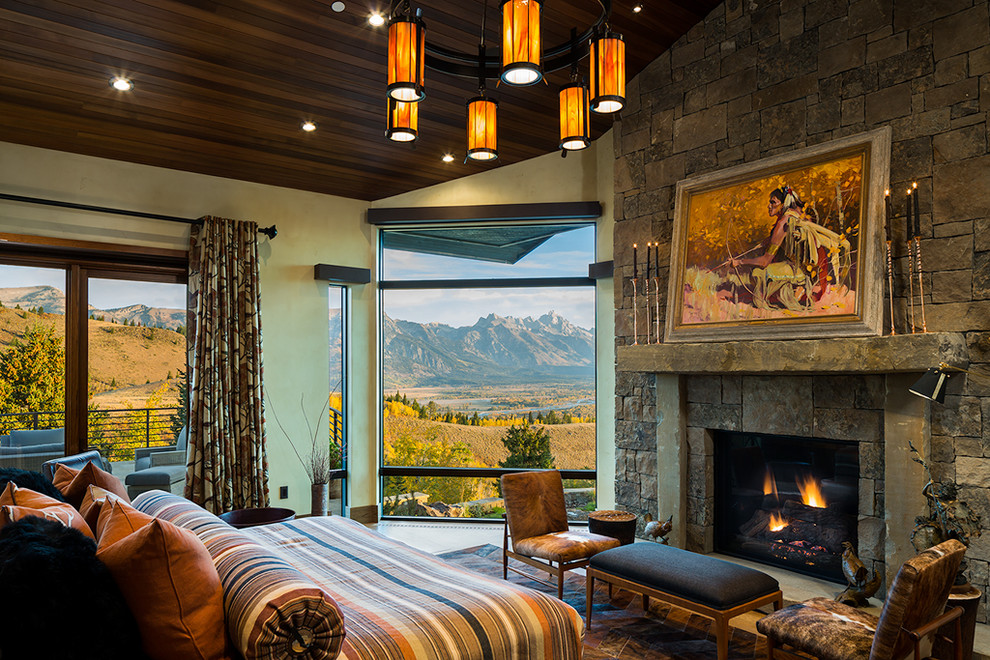 Inspiration for a huge rustic master light wood floor and beige floor bedroom remodel with a standard fireplace and beige walls