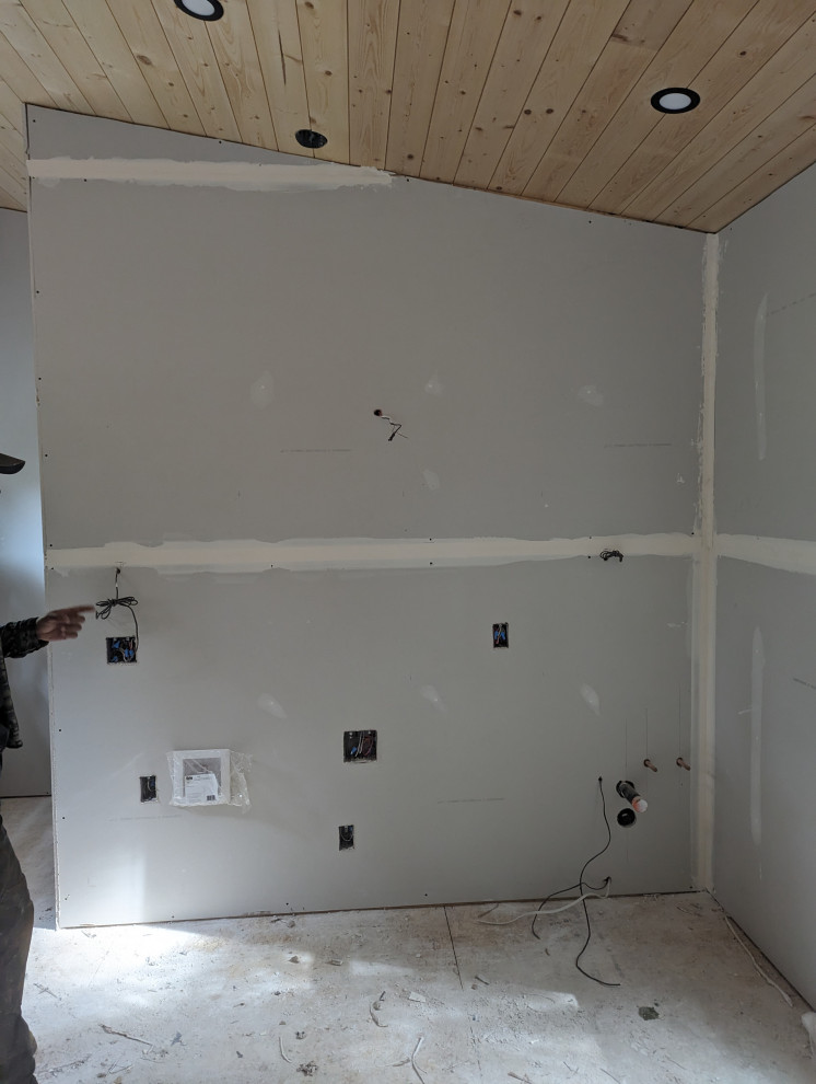 Drywall installation with electrical and plumbing rough-ins in sauna house proje