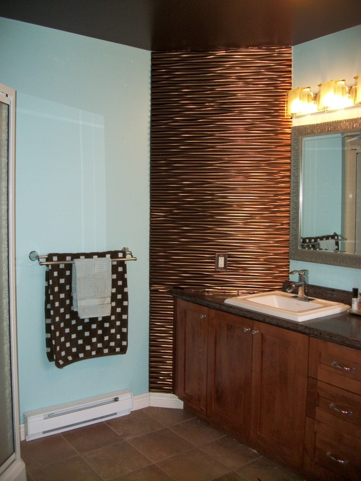 This is an example of a mid-sized contemporary master bathroom in Other with shaker cabinets, dark wood cabinets, a corner tub, a corner shower, a one-piece toilet, blue walls, ceramic floors, a drop-in sink, laminate benchtops, brown floor, a sliding shower screen and brown benchtops.