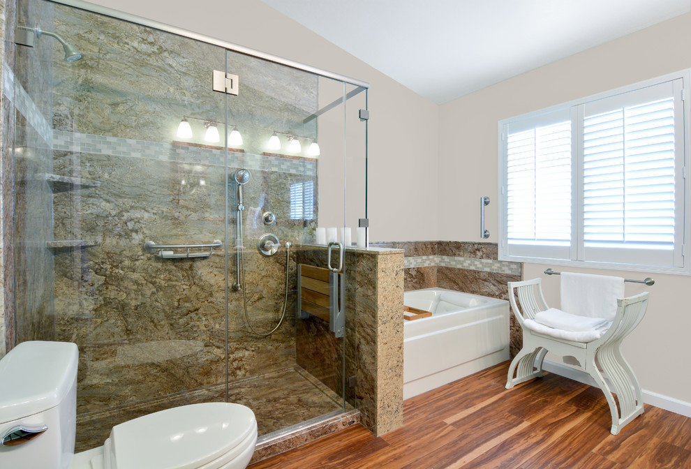 Photo of a mid-sized transitional master bathroom in San Francisco with an alcove tub, an alcove shower, a two-piece toilet, beige tile, stone slab, beige walls, vinyl floors, brown floor and a hinged shower door.
