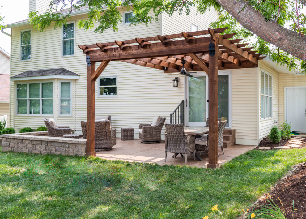 Design ideas for a small backyard patio in St Louis with stamped concrete and a pergola.
