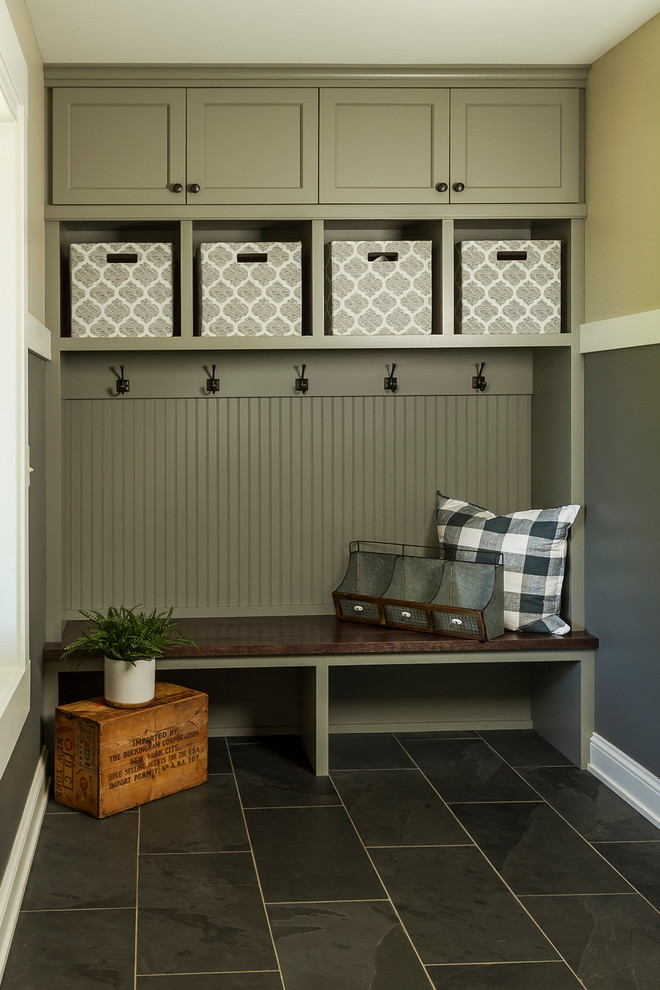 This is an example of a mid-sized country mudroom in Minneapolis with slate floors and black floor.