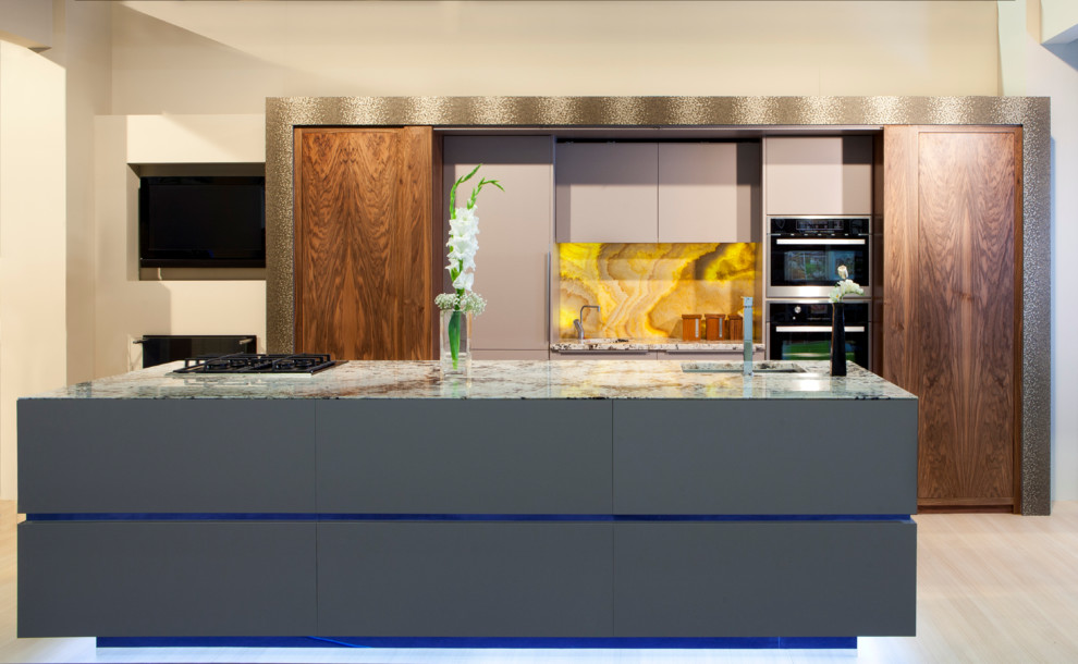 Photo of a mid-sized contemporary galley separate kitchen in Other with an undermount sink, flat-panel cabinets, dark wood cabinets, granite benchtops, yellow splashback, stone slab splashback, stainless steel appliances, light hardwood floors and with island.