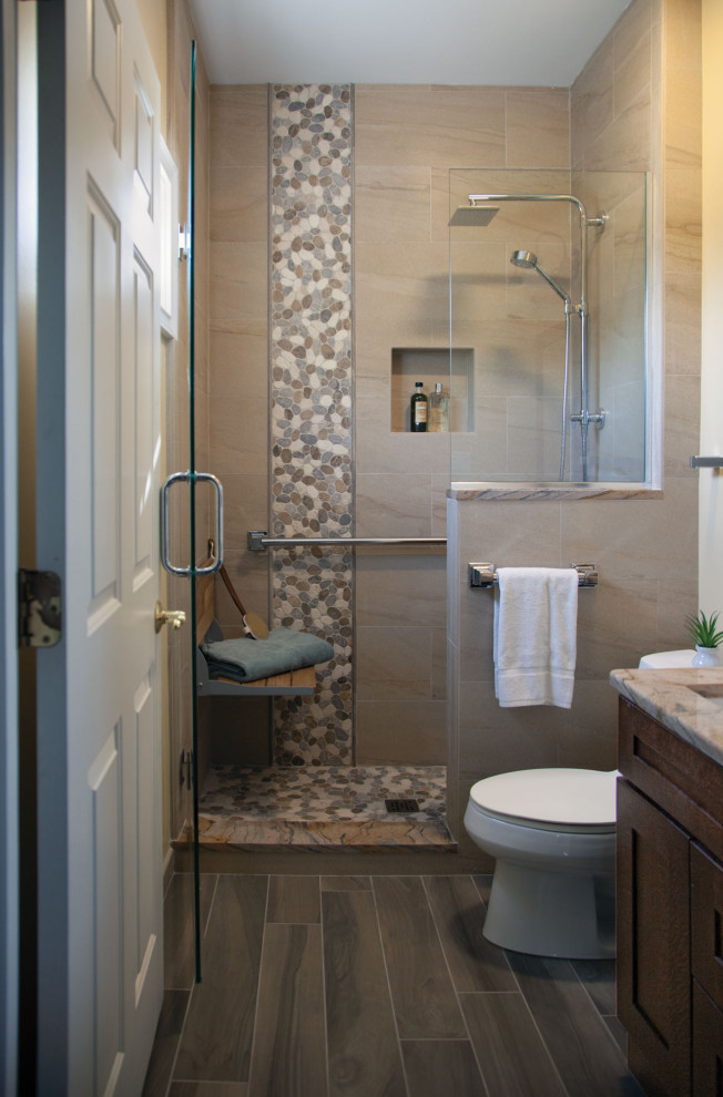 Example of a small transitional 3/4 black tile and ceramic tile ceramic tile and brown floor doorless shower design with shaker cabinets, brown cabinets, a one-piece toilet, beige walls, an undermount sink, granite countertops, a hinged shower door and beige countertops