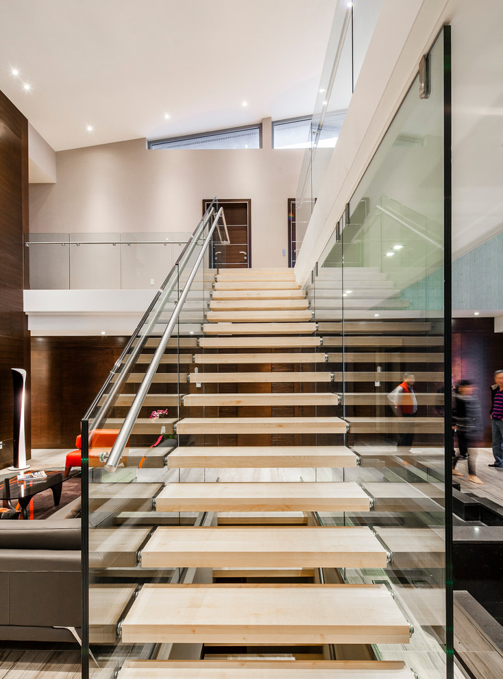 Large contemporary wood straight staircase in Toronto with open risers.
