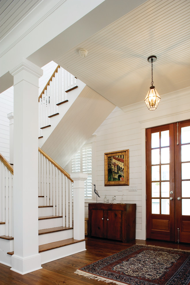 Photo of a traditional foyer in Charleston with white walls, a double front door and a dark wood front door.