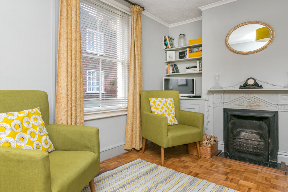 Medium sized retro enclosed living room in Kent with a reading nook, grey walls and dark hardwood flooring.