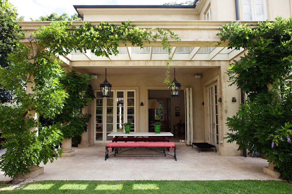 Photo of a large traditional backyard patio in Sydney with natural stone pavers.
